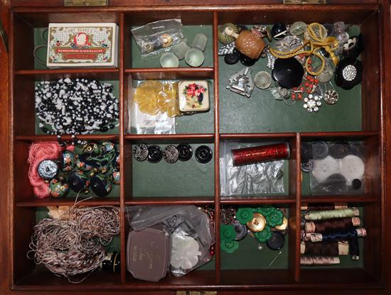 A mahogany box of sewing related items